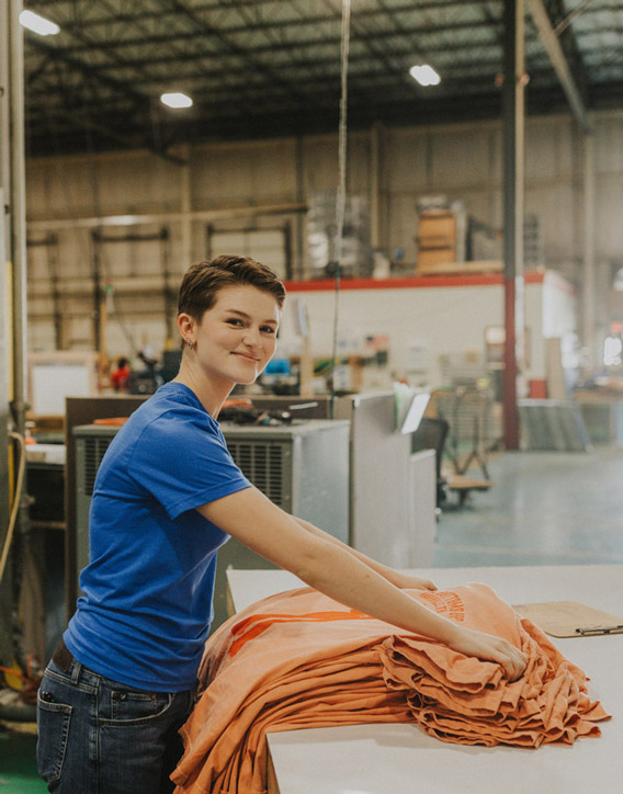 Image of person working on custom apparel